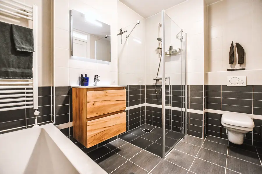 Newly renovated bathroom with tiled shower and modern vanity in a Boston-area home